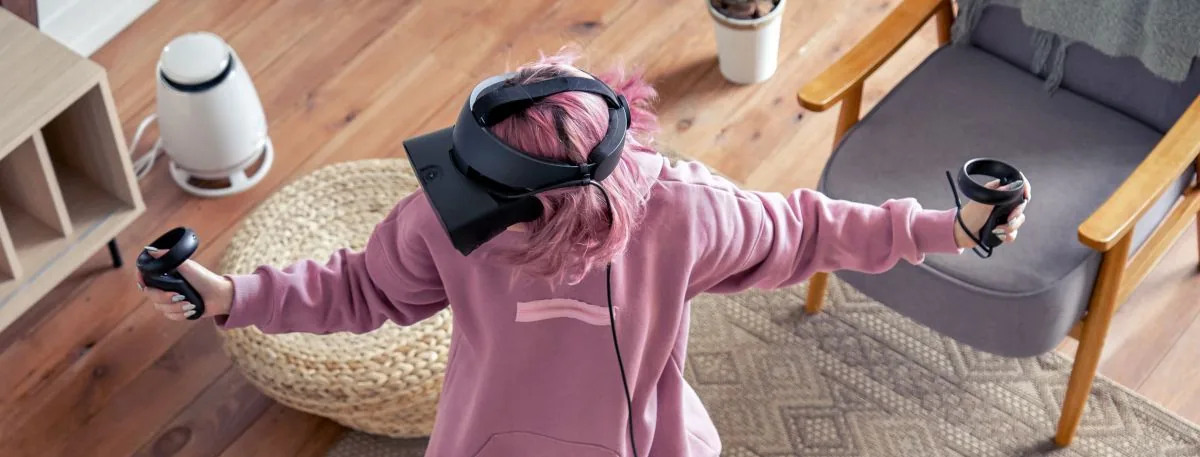 Person playing room-scale VR in a living room